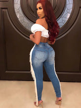 Vaqueros ajustados con cremallera y borlas rasgadas de Danim